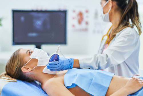 doctor-in-mask-checking-thyroid